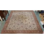 A 20th century cream ground eastern style rug with all over design and dark red borders, 365cm