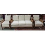 A 20th century mahogany framed bergere three piece suite with two seater sofa and pair of