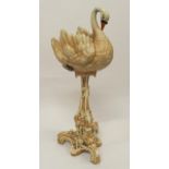 A ceramic jardinière in the form of a swan with scrolled floral decorated base, 97cm high