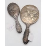 A silver hand mirror with cast decoration of Reynold's Angels, by William Comyns, London 1907, and
