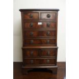 A 20th century mahogany apprentice style chest on chest with two over three drawer on a two over one