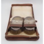 A leather cased silver mounted brush set, with two brushes and a comb, by S. Blanckensee & Son