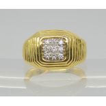 An 18ct gold ribbed design signet ring set with nine diamonds, with an estimated approx 0.09cts of