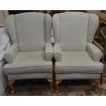 A pair of contemporary wing back armchairs with light grey upholstery on cabriole supports (2)