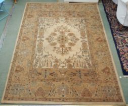 A modern cream ground machine made rug with floral central medallion and flower head border, 287cm