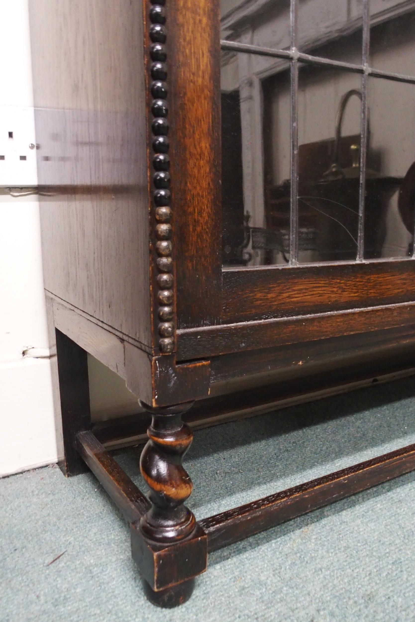 A 20th century oak three tier leaded glass fall front bookcase on stretchered barley twist supports, - Image 3 of 3