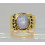 A 14k gold pale blue star sapphire and blue sapphire ring, size L1/2, weight 11.8gms Condition