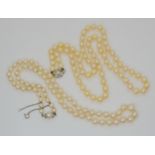 A string of good quality light cream cultured pearls with a pearl and diamond screw clasp, largest