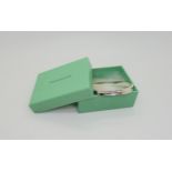 A silver Tiffany & Co bangle, in original box, the bangle stamped 925 T&Co 1837 and to the inner