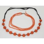A string of statement woven coral beads, with black glass beads and ribbon strap. Each woven bead is
