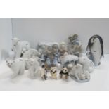 A collection of Lladro polar bear and Eskimo figures together with a penguin and chick figure and