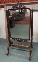 A Victorian mahogany cheval mirror with turned uprights on stretchered scrolled base, 143cm high x