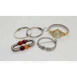 A Victorian white metal mounted carved agate brooch, a silver pen annular brooch, two babies bangles