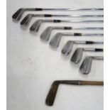 A hickory shaft golf iron by A. Patric, Leven; together with a set of eight 1950s golf irons by