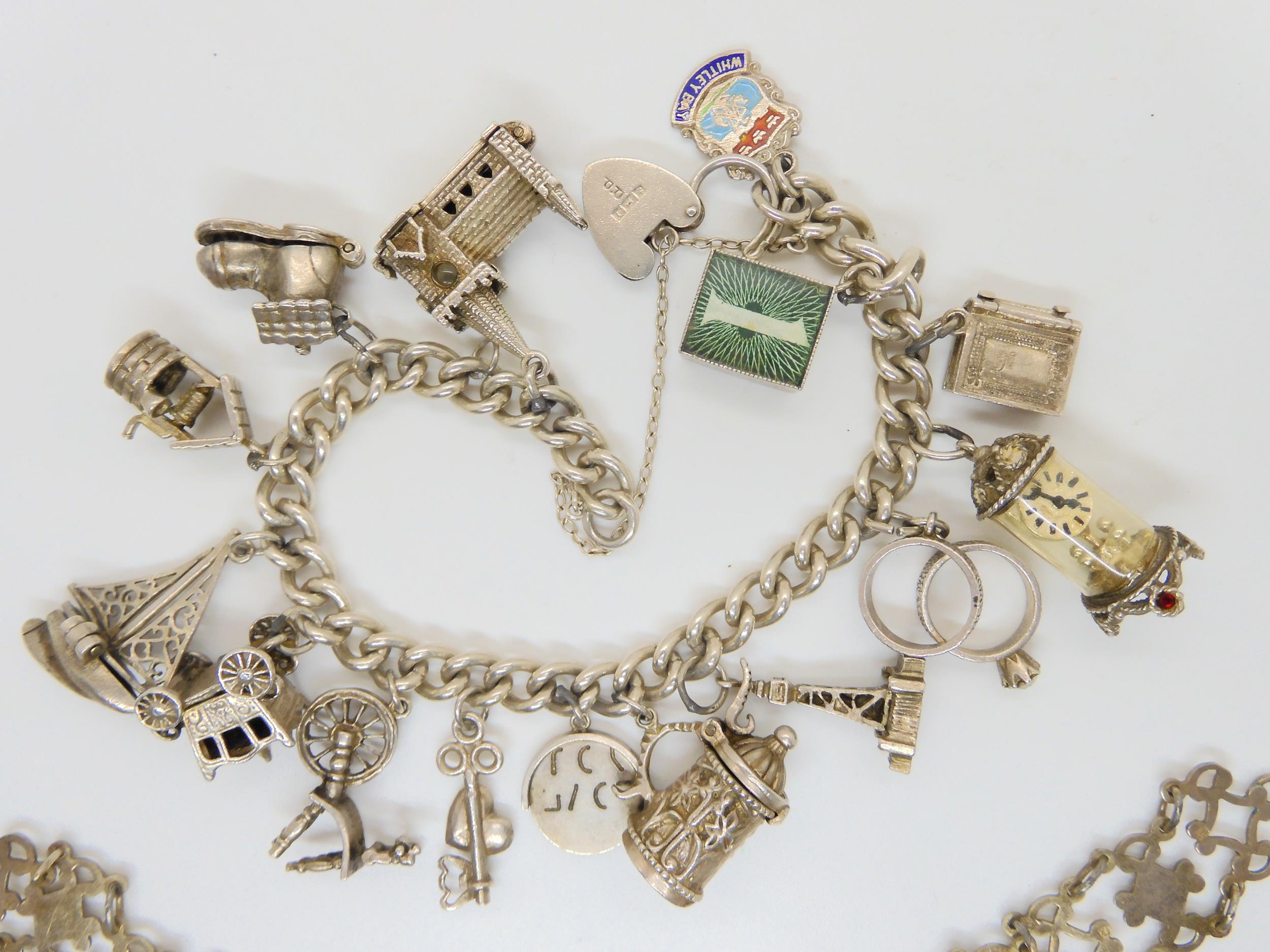 A silver charm bracelet with fifteen attached silver and white metal charms, and a silver bracelet - Image 3 of 3