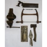 A Woden bench vice, with a small collection of vintage tools, including a fret saw, a tenon saw, a
