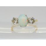 An 18ct and platinum opal and diamond ring, set with estimated approx 0.66cts of brilliant cut