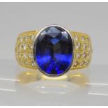 A 14k gold ring set with a vermeil synthetic sapphire and clear gems, size P1/2, weight 9gms