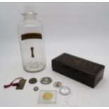 A clear glass chemist's jar, a black lacquer box and assorted replica/commemorative coins etc.