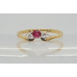 A 9ct gold ruby and diamond three stone ring, set with estimated approx 0.08cts of brilliant cut