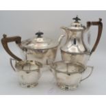 A four piece silver tea service, of faceted form, by Wilson & Sharp, Sheffield 1933, with engraved