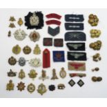A collection of military cap badges and buttons, to include the Cameron Highlanders, King's Own