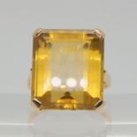 A yellow metal ring set with a large step cut citrine, dimensions 16.7mm x 14.5mm x 8.9mm, size L1/