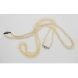 Two strings of cultured pearls, one with a 9ct white gold diamond set clasp Condition Report:Not