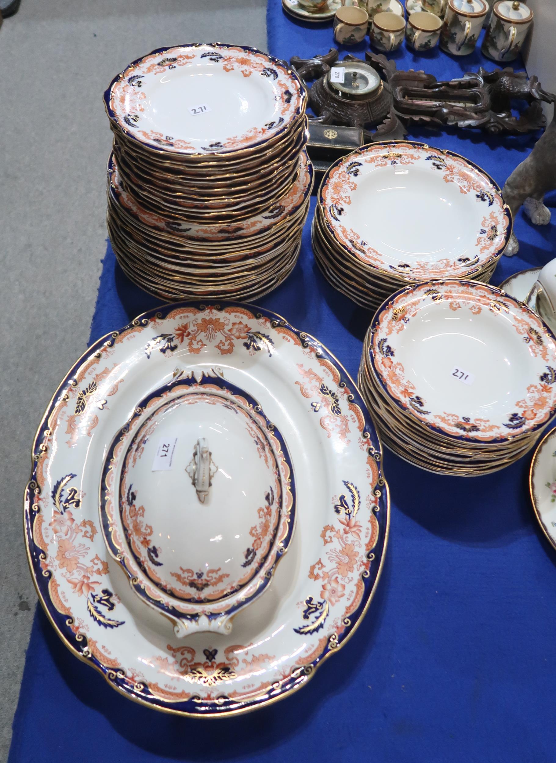 A Royal Crown Derby dinner service comprising dinner plates, side plates, pudding bowls, soup bowls,
