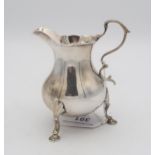 An early George III silver cream jug, of baluster form with an S scroll handle, supported on three