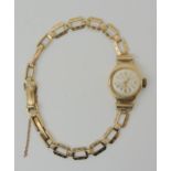 A 9ct gold ladies Roma watch and strap, weight including mechanism 12.5gms Condition Report: