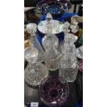 Assorted cut glass and crystal decanters, together with studio pottery dishes in purple and blue