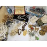 A large collection of vintage costume jewellery to include Bohemian beads, a retro pendant and other