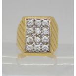 A bright yellow metal ring set with pave set clear gems, finger size M, weight 5.8gms Condition