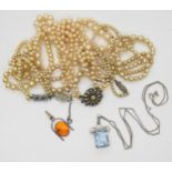 A silver aquamarine pendant and chain, a silver amber pendant and a collection of faux pearls.