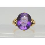 A yellow metal ring set with an amethyst, of approx 14.54mm x 12.3mm x 8.1mm, finger size M1/2,