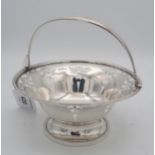 A silver swing handled basket, the body with openwork Art Nouveau decoration, with beaded rims and