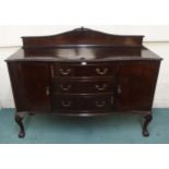 A 20th century mahogany serpentine front sideboard with three central drawers flanked by cabinet