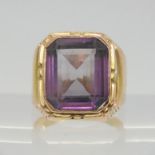 A yellow metal ring with Arabic hallmarks, set with a faux amethyst, size N1/2, weight 8.8gms