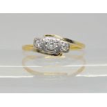 An 18ct gold vintage three stone diamond ring, set with estimated approx 0.10cts of brilliant cut