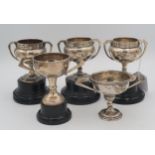 A collection of five silver presentation trophy cups, two from the Lansdowne Church Golf Club,