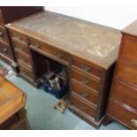 A Victorian oak twin pedestal desk with central drawer containing writing slope flanked by four