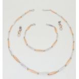 A 9ct white and rose coloured gold baton link necklace with matching bracelet and diamond set