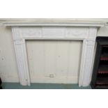 A 19th century pine and plaster whited painted fire surround with cast central relief depicting