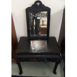 A late 19th century Oriental ebonised table with carved friezes on shaped supports and an ebonised