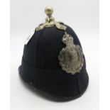 An early 20th century policeman's helmet, leather lined, bearing a possibly unassociated Guernsey