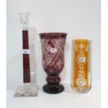 A ruby flashed and cut glass vase, an amber example and a candlestick Condition Report:Available