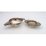 A silver tea strainer, the handles formed as openwork shells, by Royal Irish Silver Co, Sheffield