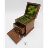 A rosewood jewellery box of small cubic proportions, the hinged top and fall-front opening to reveal