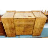 A 20th century walnut veneered Art Deco inverted breakfront sideboard with cabinet doors flanking